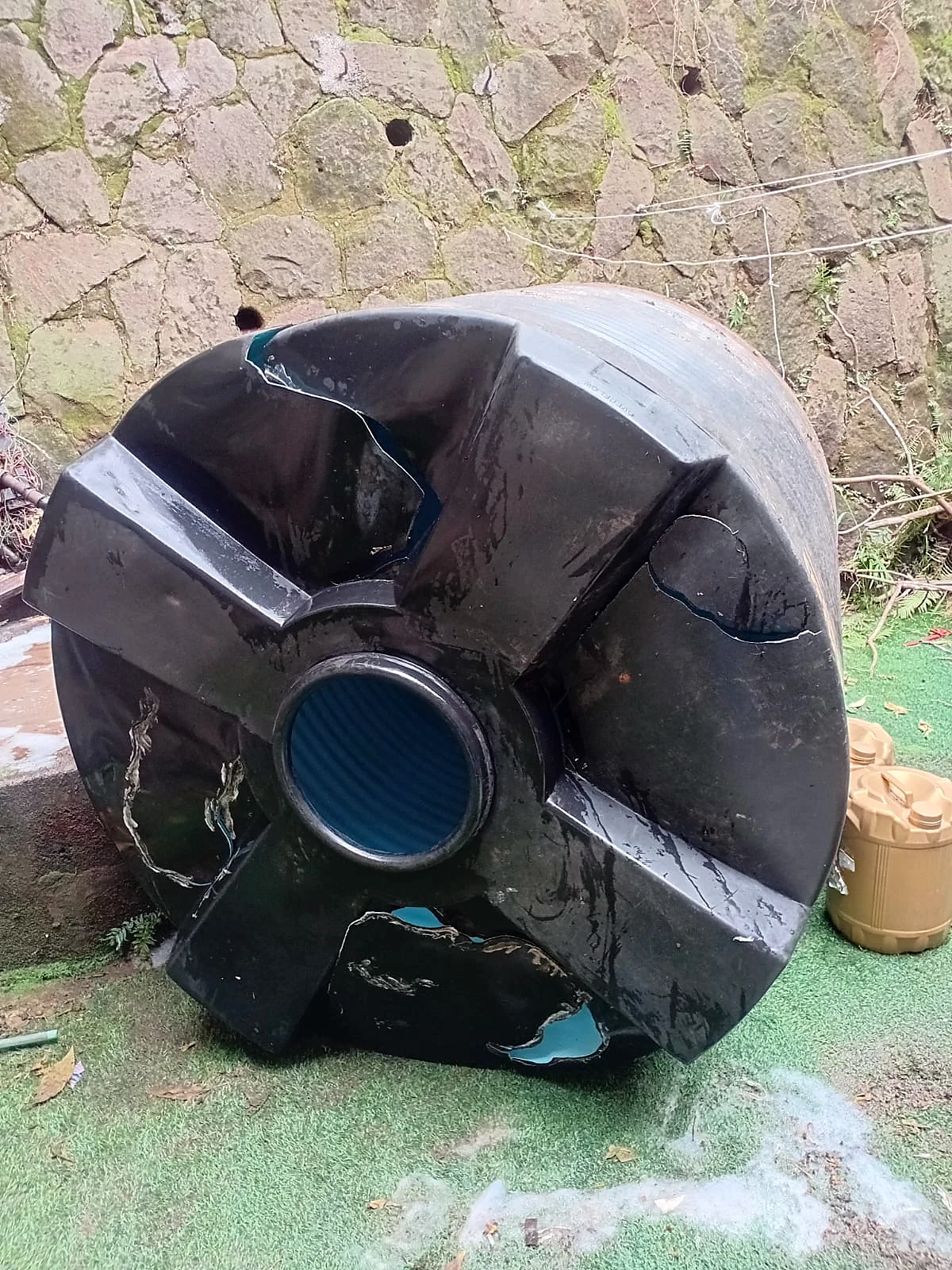 A split black tank welded and restored â before repair